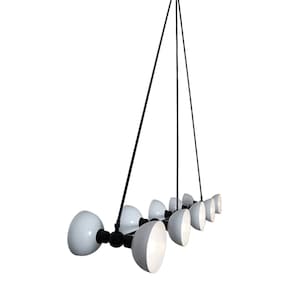 May include: A black metal chandelier with eight white globe-shaped light shades. The chandelier has a long, thin design and hangs from a single point.