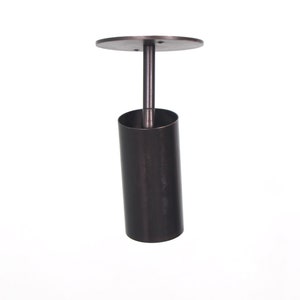 May include: A black metal ceiling light fixture with a cylindrical shade and a round canopy.