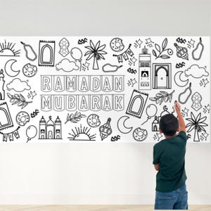 May include: A black and white coloring page featuring a variety of Islamic symbols and the phrase "Ramadan Mubarak". The page is designed for children to color in.