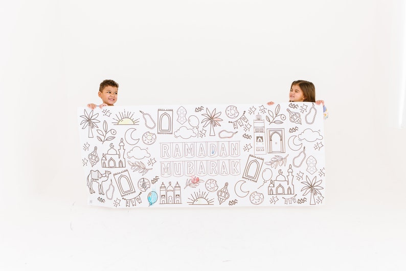 May include: Two children hold up a large white banner with black line drawings of Islamic symbols and the text "Ramadan Mubarak".
