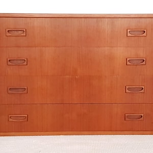 May include: A four-drawer chest of drawers made from light brown wood with simple, rectangular handles.
