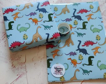 May include: Two sheets of blue wrapping paper with a dinosaur pattern. The paper is 70x90cm and 115gsm silk.