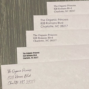 May include: Five white envelopes with the address "The Organic Princess, 828 Romans Blvd, Charlotte, NC 28217" written on each one.