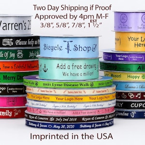 May include: A collection of stacked spools of satin ribbon in various colors including black, green, orange, blue, yellow, purple, pink, and white. Each ribbon features custom printed text, logos, and graphics in different fonts and sizes.