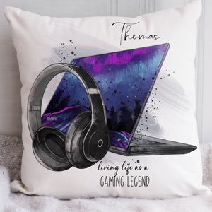Peut inclure: Oreiller blanc avec une illustration en noir et blanc d'un ordinateur portable et d'un casque. Le texte "Thomas" est en haut de l'oreiller. Le texte "living life as a GAMING LEGEND" est en bas de l'oreiller.