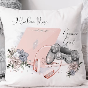 May include: A white pillow with the text "Harlow Rose Gamer Girl" printed on it. The pillow features a pink laptop, a gaming controller, and headphones with floral accents.