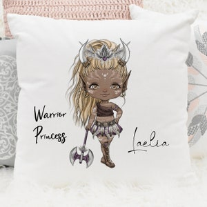 May include: White pillow with a cartoon illustration of a warrior princess with blonde hair, brown skin, and a purple axe. The text "Warrior Princess" and the name "Laelia" are printed on the pillow.