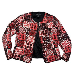 May include: A quilted jacket with a patchwork design. The jacket features a mix of red, black, and white squares with floral and geometric patterns. It has long sleeves and a black lining. The jacket is open in the front.