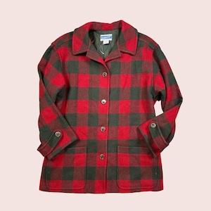 May include: A red and green plaid jacket with a button-up front, two front pockets, and buttoned cuffs. The jacket has a collar and is made of a thick, woven fabric. The brand name "Pendleton" is visible on the label.