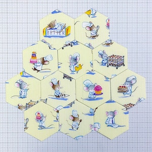 May include: A set of 12 yellow hexagon-shaped fabric patches featuring illustrations of mice wearing chef hats and baking. The patches have a white background with blue and red accents. The text "Butter" is printed on one of the patches.
