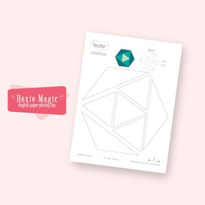 May include: A white paper with geometric shapes and the text "Hexie Magic" in a pink banner. The paper features a diagram of a geometric shape, with a teal and green geometric shape in the upper right corner.