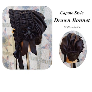 May include: A black satin capote style drawn bonnet with a black satin bow and a small black flower with a silver center. The bonnet is on a mannequin head. The text "Capote Style Drawn Bonnet 1790-1840's" is visible in the image.