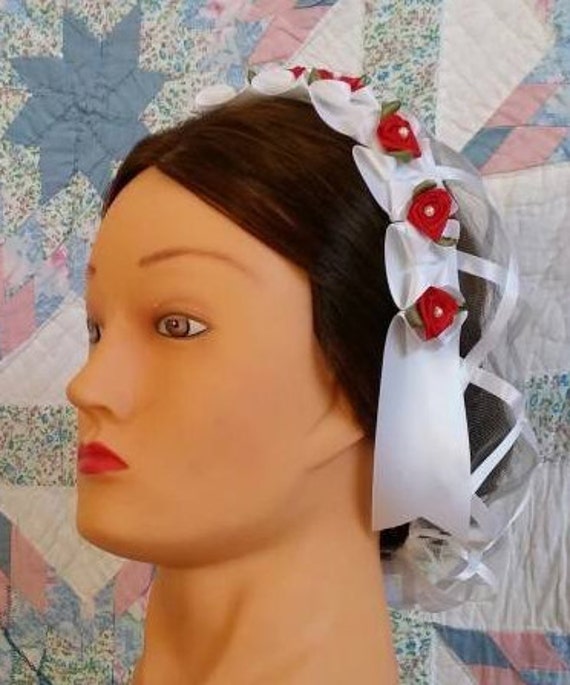 White Ribbon Hairnet With Red Satin Ribbon Roses on a White