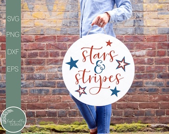 May include: A white round sign with the text "stars & stripes" in red cursive lettering. There are four red, white, and blue stars around the text.