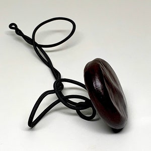 Sea Heart Hair Tie Lasso Is made from a bean that grows on trees in Europe. It can be worn as a necklace. Check it out image 3