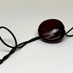 Sea Heart Hair Tie Lasso Is made from a bean that grows on trees in Europe. It can be worn as a necklace. Check it out image 6