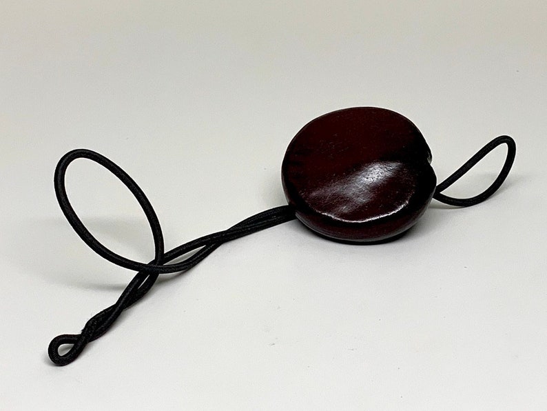 Sea Heart Hair Tie Lasso Is made from a bean that grows on trees in Europe. It can be worn as a necklace. Check it out image 6