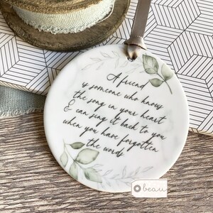 A .... is someone who knows the song in your heart Friend Relative Quote Round Ceramic Hanging - Keepsake