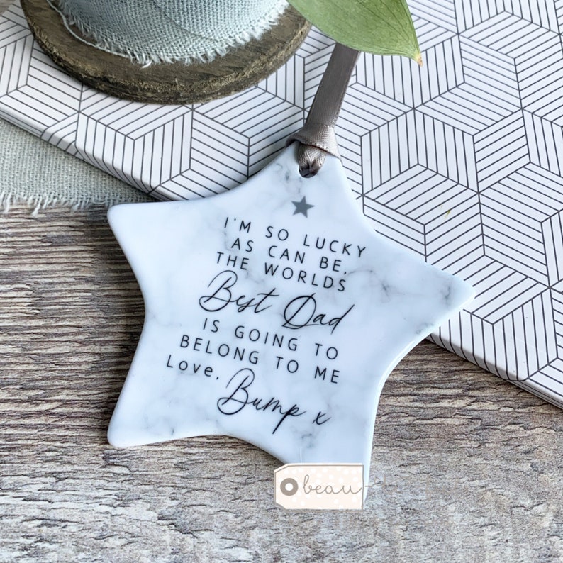 This ceramic star keepsake come with a sentimental message. It is designed  with marble style background and plain white back. It is hung with ribbon.