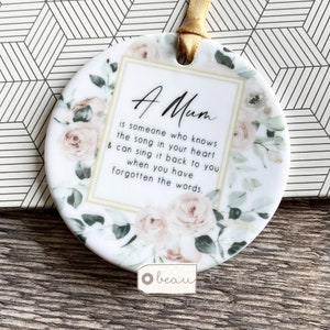 A .... is someone who knows the song in your heart Friend Relative Quote Round Ceramic Hanging - Keepsake