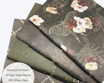 May include: A stack of folded paper sheets featuring dark brown and olive green tones with floral and insect motifs. A circular white label displays the text: Choose from 12 Sizes & 35 Paper Pattern Options 28lb/104gsm Paper in White or Cream.