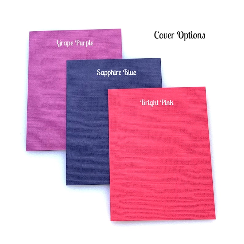 May include: Three notebook cover options: Grape Purple, Sapphire Blue, and Bright Pink. The covers are textured and have a subtle sheen.