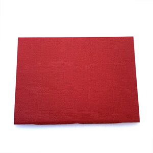 May include: A solid red card stock paper sheet.