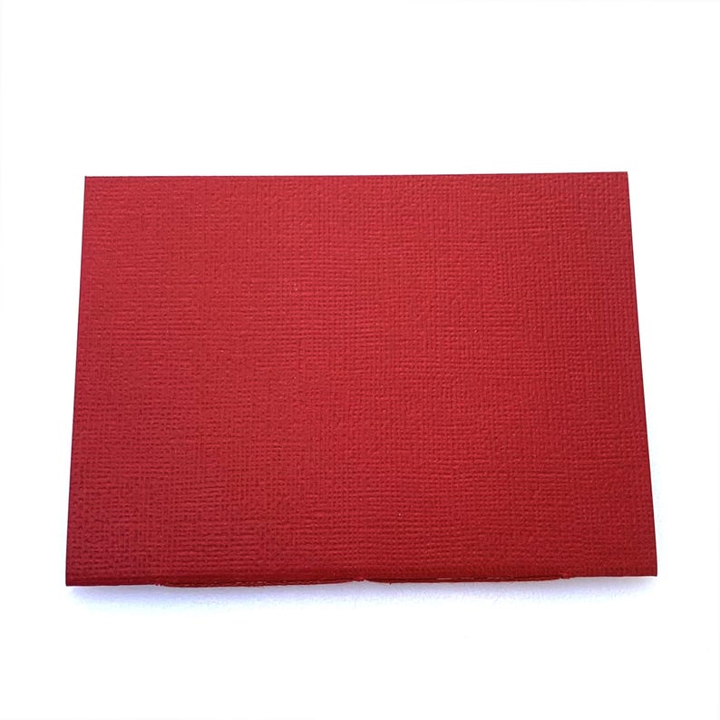 May include: A solid red card stock paper sheet.