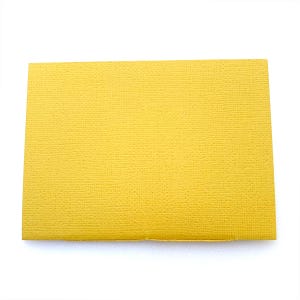 May include: A yellow card stock paper with a textured surface.