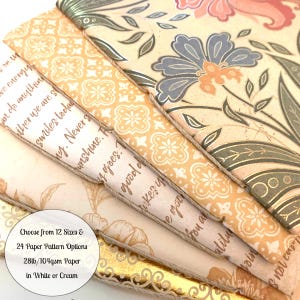 May include: A stack of five handmade journals with different patterned covers. The covers are made of 28lb/104gsm paper in white or cream. The journals are available in 12 sizes and 24 paper pattern options. Choose from 12 Sizes & 24 Paper Pattern Options 28lb/104gsm Paper in White or Cream