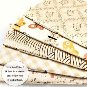 May include: A stack of six patterned paper sheets in various designs, including butterflies, floral patterns, and geometric shapes. The paper is 28lb/104gsm and available in white or cream. Choose from 12 sizes and 24 paper pattern options.