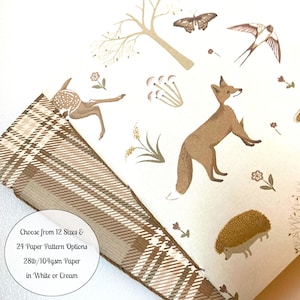 May include: A woodland-themed wrapping paper design featuring a fox, deer, hedgehog, butterfly, and birds. The paper is available in 12 sizes and 24 patterns, printed on 28lb/104gsm paper in white or cream.