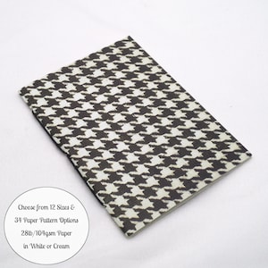 May include: A rectangular notebook featuring a black and white houndstooth pattern. A circular white label includes the text: Choose from 12 Sizes & 34 Paper Pattern Options 28lb/104gsm Paper in White or Cream.