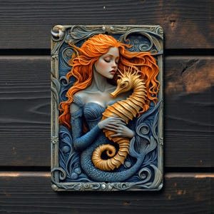 May include: A rectangular wall plaque featuring a mermaid with flowing orange hair, embracing a golden seahorse. The mermaid is depicted in a blue dress with a fishtail, set against a detailed, ornate frame.