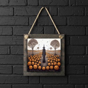 May include: A Halloween-themed wall art print featuring a spooky scene. The artwork depicts a path lined with carved pumpkins leading to a tall, dark figure. Two large trees frame the scene, with birds in the sky. The print is framed in a rustic wooden frame and hangs by a rope.