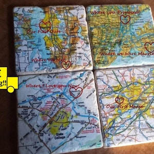 Pode incluir: Conjunto de quatro  tapetes quadrados com mapas que têm corações vermelhos que marcam locais especiais. O texto nos tapetes diz "Where you Proposed!", "Our First Date", "Where we Were Married", e "Where I Love you Now!"