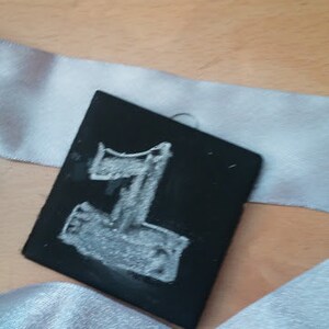 May include: A black chalkboard with the number "1" written in white chalk.