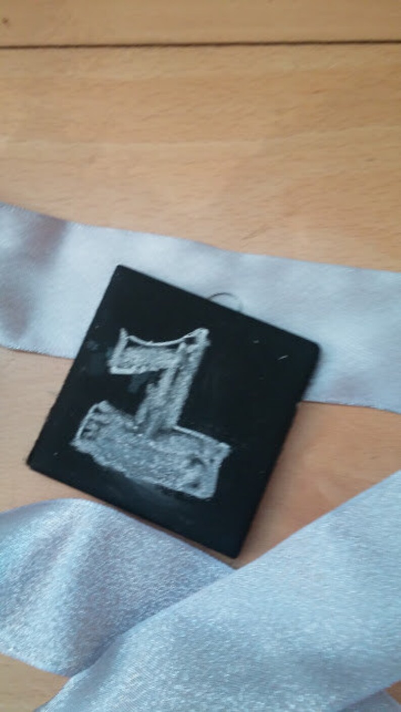 May include: A black chalkboard with the number "1" written in white chalk.