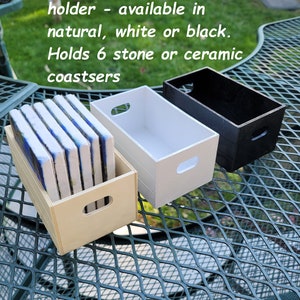 May include: Three rectangular wooden crate-style coaster holders in natural, white, and black finishes. The text OPTIONAL wood coaster holder - available in natural, white or black. Holds 6 stone or ceramic coastsers is visible above the crates.