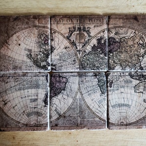 May include: A set of six vintage-style coasters featuring a world map. The map is divided into six sections, each with a different continent. The coasters are made of a light brown material with a slightly textured surface.