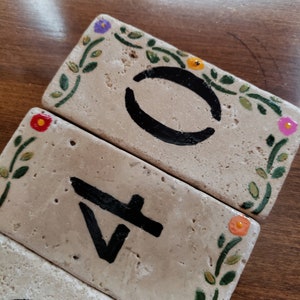 May include: Three rectangular tiles with painted floral designs and black numbers. The tiles read "0", "4", and "1".