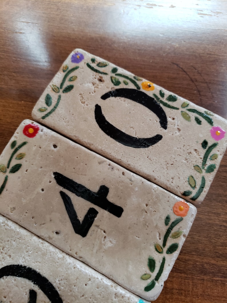 May include: Three rectangular tiles with painted floral designs and black numbers. The tiles read "0", "4", and "1".