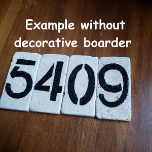 May include: Close-up of four white ceramic tiles with black painted numbers, reading "5409". The tiles are arranged in a row on a wooden surface.