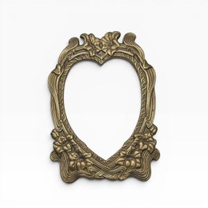May include: An oval-shaped brass picture frame featuring intricate relief carvings of floral motifs and flowing, organic lines. The metal has a muted, antique gold finish with detailed textures throughout the border and decorative elements.