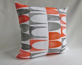 Burnt orange pillow cover with a mid century modern inspired block printed design on white cotton