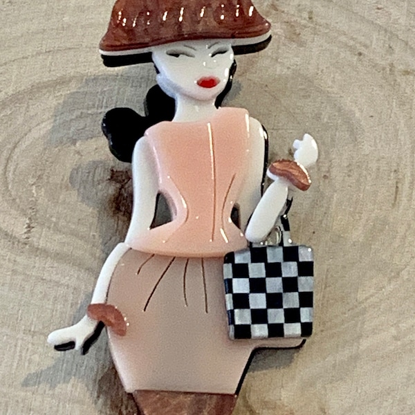 3D acrylic brooch of lady with handbag and hat. Ready to shop