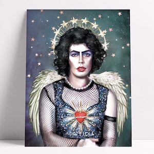 May include: A digital illustration of a person with dark hair and makeup wearing a sparkly blue top with a red heart and a halo of stars. The person is wearing a pearl necklace and has angel wings. The text "DIRTY LOLA" is at the bottom of the image.