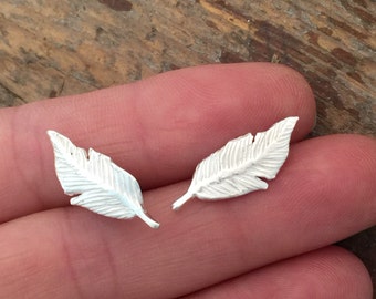 Silver feather stud earrings.