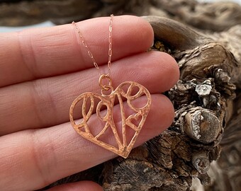 Rose gold love heart necklace.