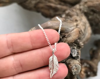 Dainty silver feather necklace.